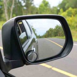 You can reduce your vehicle's blind spot by_______.